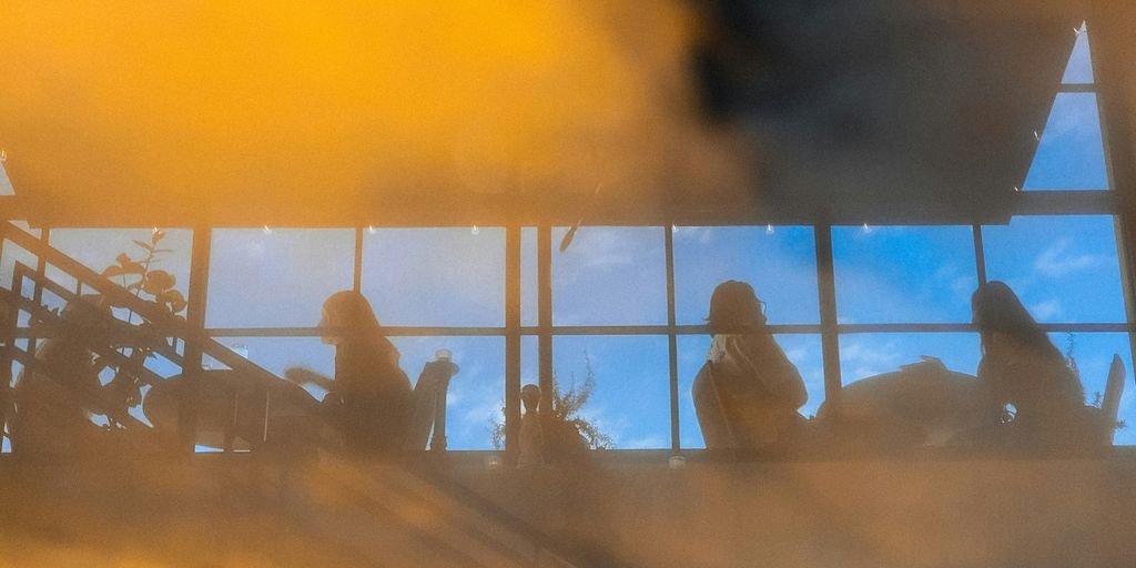 a group of people standing in front of a window